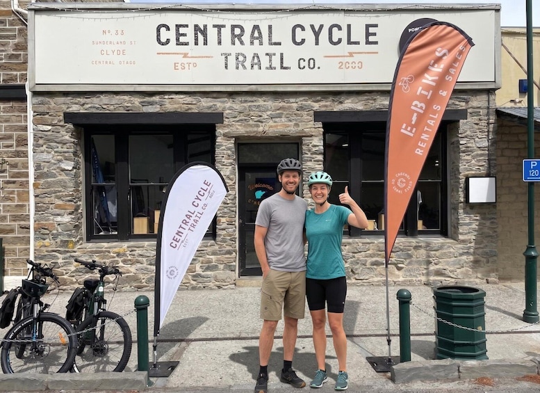 A couple standing in front of Central Cycle Trail Co. with bicycles parked nearby. 2