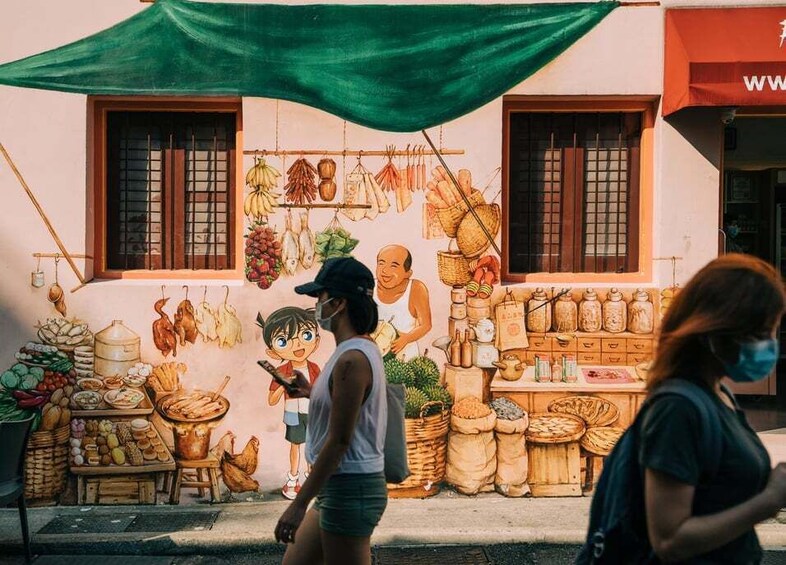 A street scene with a mural depicting a market, including hanging vegetables and a vendor. 5