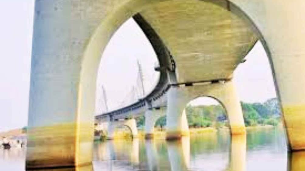 A bridge with multiple arches over a body of water. 5