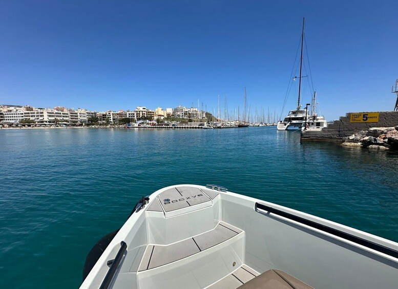 A marina with boats, a speed limit sign, and buildings along the waterfront. 3