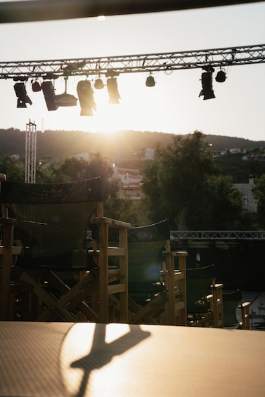 A stage with lighting equipment and a chair in the foreground. 2