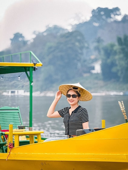 A person on a yellow boat with a green structure and a chair. 5