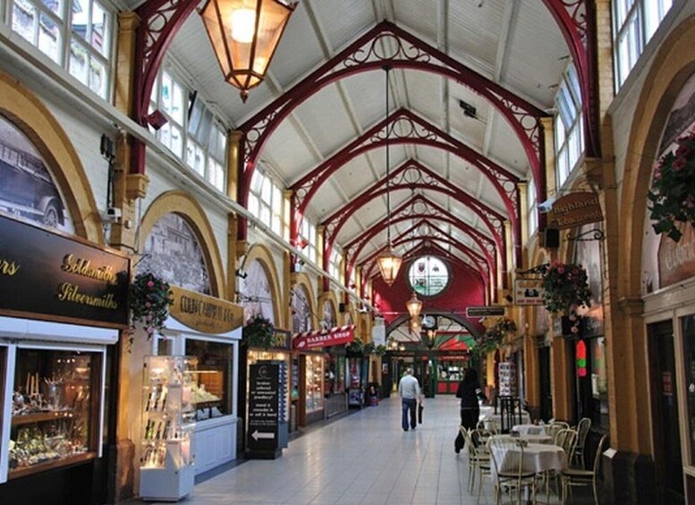 An indoor market with arched ceilings and shops on either side. 2