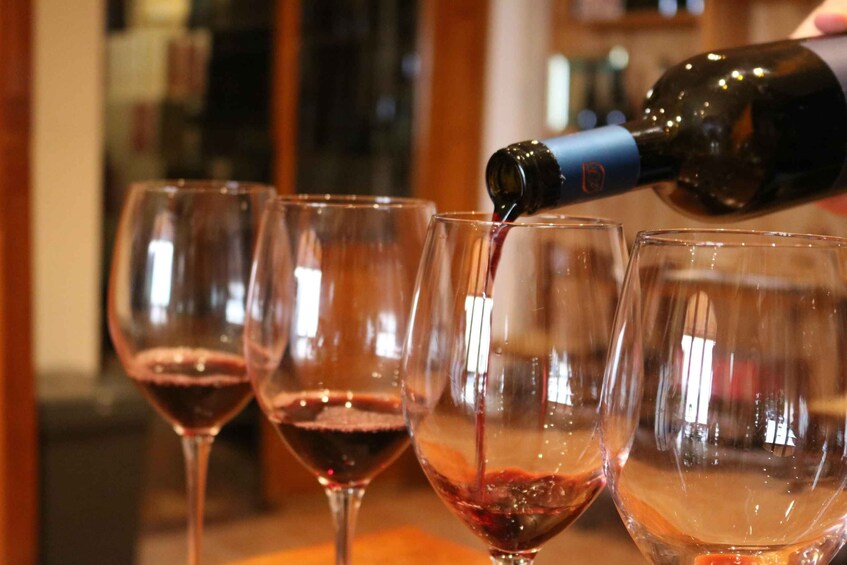 A bottle being poured into a glass. 1