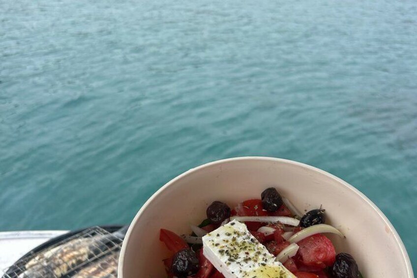 A bowl of fruit salad with strawberries, blackberries, and a white cheese on a boat. 1