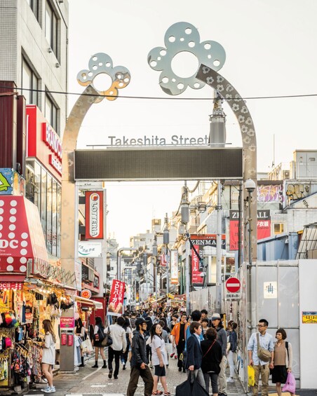 Takeshita Street with a crowd of people, shops, and a distinctive archway. 1