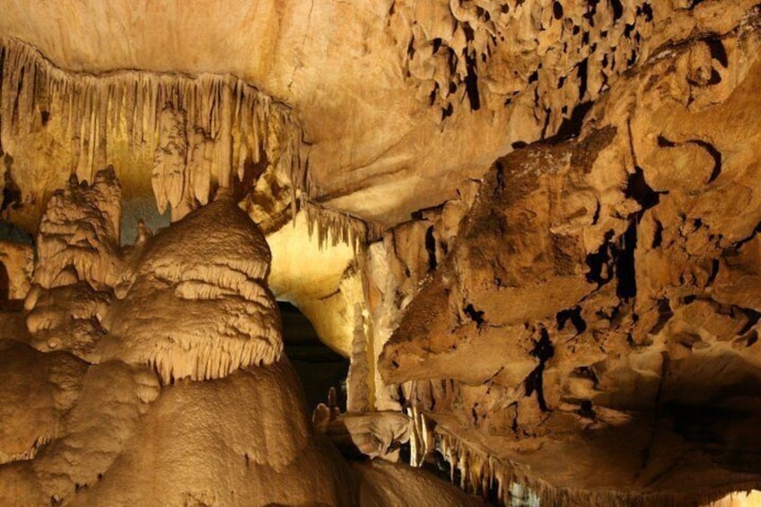 A cave interior with stalactites and stalagmites. 4