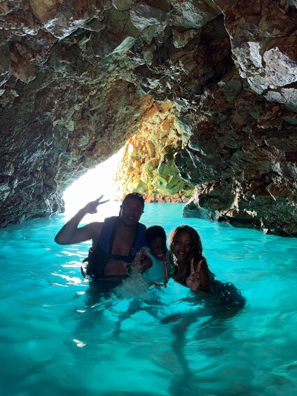 A cave with turquoise water and rocky walls. 2