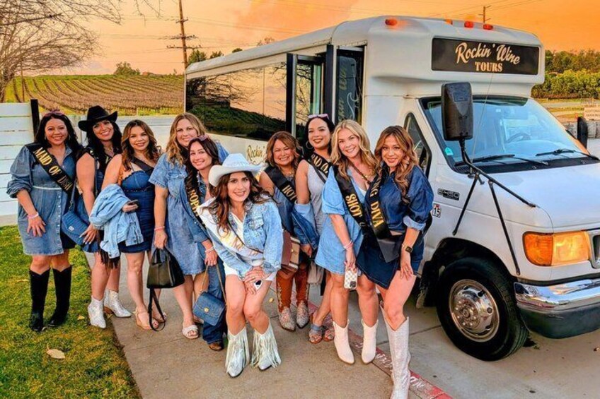 A group of people in front of a bus with 'Rockin' Wine Tours' on it. 4