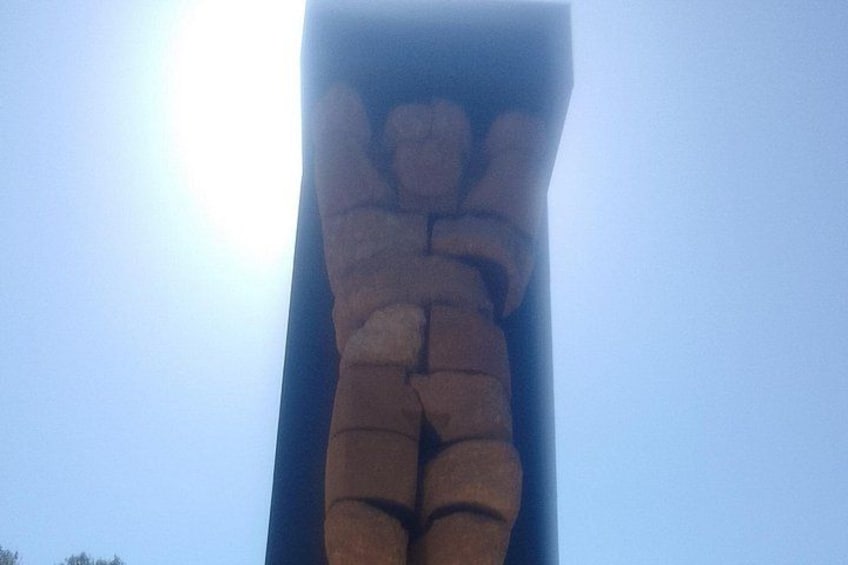 A large, abstract sculpture against a clear sky. 4