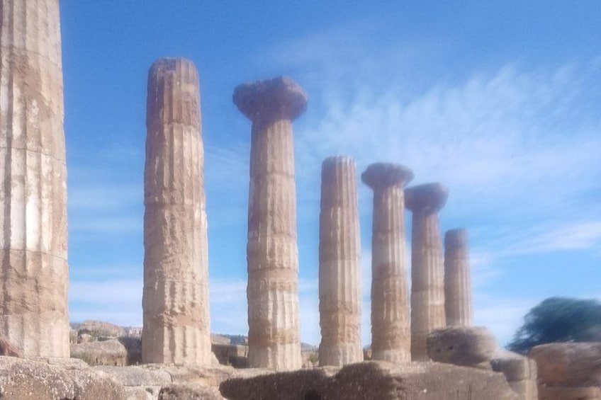 Ancient stone columns with capitals, set against a clear sky. 3