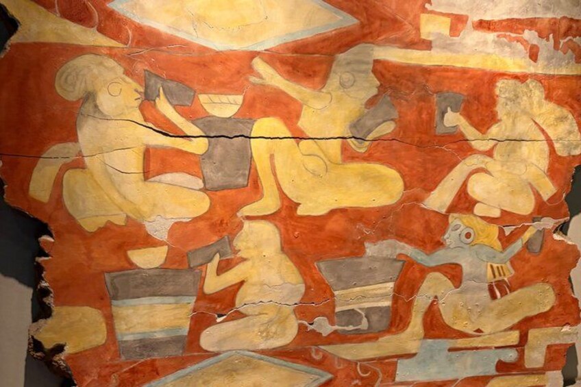 A mural with figures and abstract shapes, possibly depicting a historical or cultural scene. 4