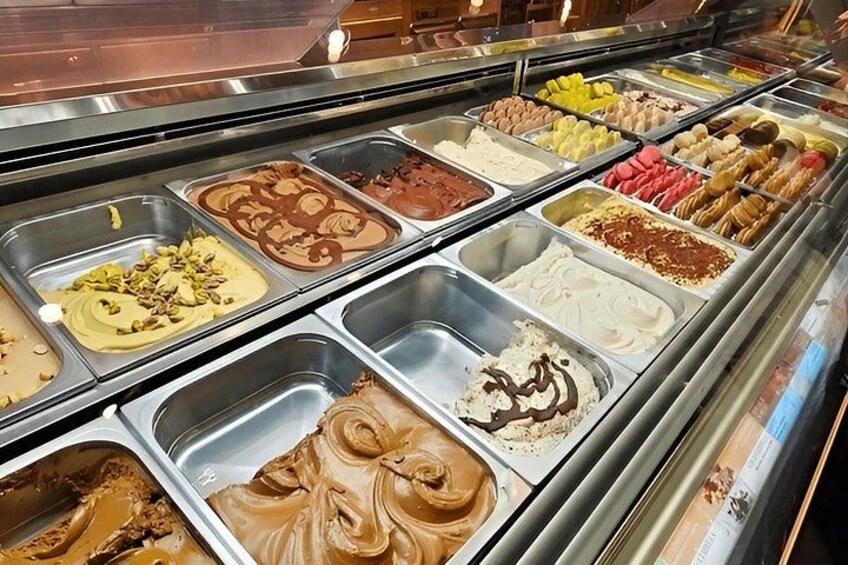 A variety of ice cream flavors in a display case. 2