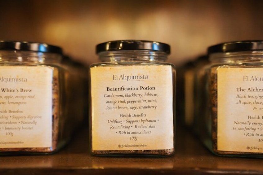 Three glass jars with labels on a shelf. 2