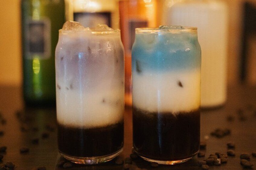 Two glasses of iced coffee with ice cubes on a table. 4