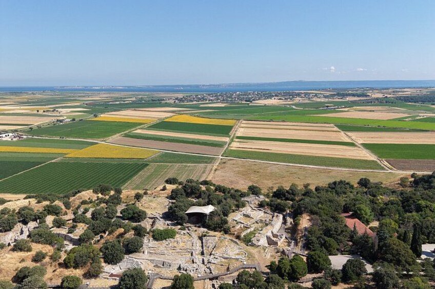 An aerial view of a rural landscape with fields, trees, and ruins. 3