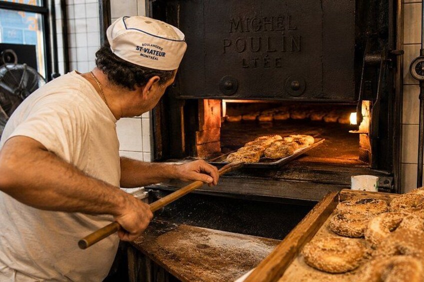 A person baking in a professional oven with a sign that reads 'MICHEL POULIN LITE.' 4
