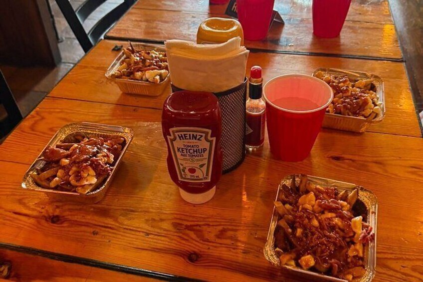 A wooden table with food items and condiments. 2