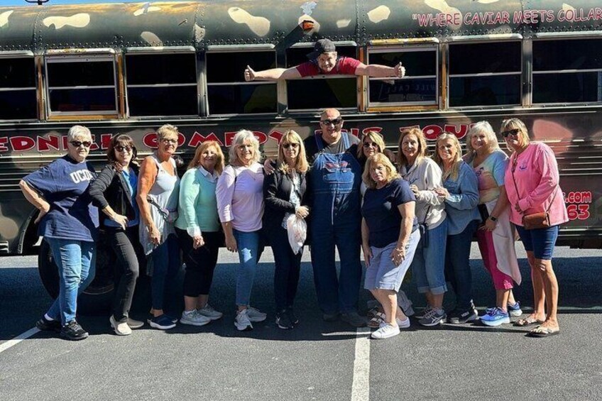 A group of people posing in front of a vintage bus with the text 'CAVIER MEETS COLLAR' on its side. 2