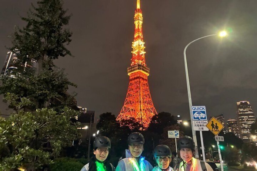 A brightly lit Eiffel Tower at night with a 'QUICK' sign and a pedestrian crossing sign in the foreground. 5