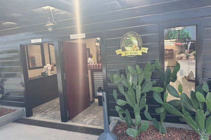 A storefront with an 'OPEN' sign, a 'Bay Islands' logo, and a 'Palm Company' emblem. 4