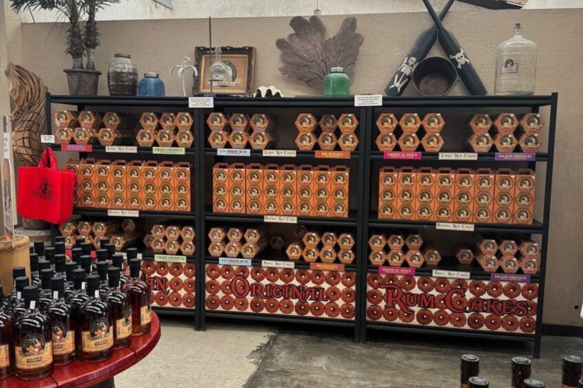 Shelves stocked with rum cakes and bottles of rum. 5