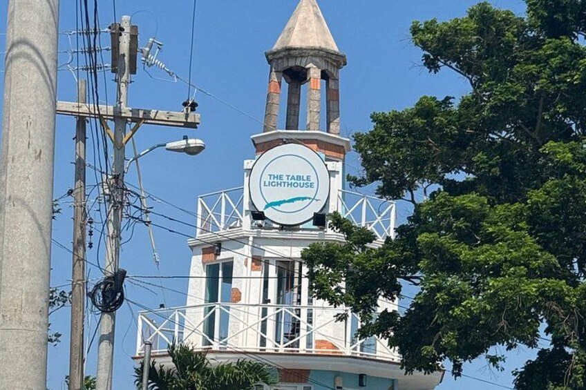 A lighthouse with a sign reading 'The Table Lighthouse' and a tower structure. 3
