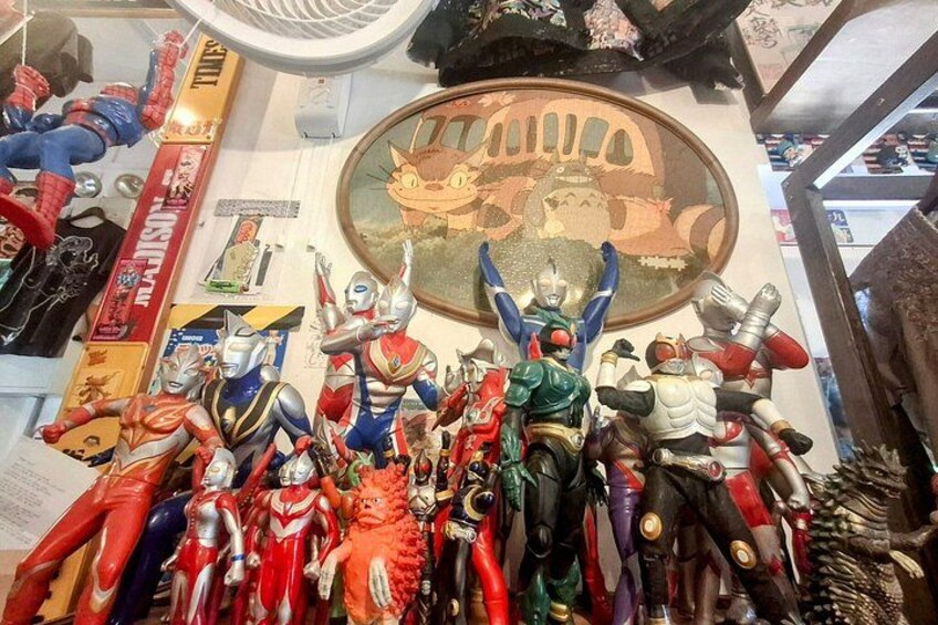 A collection of action figures and memorabilia on a wall. 2