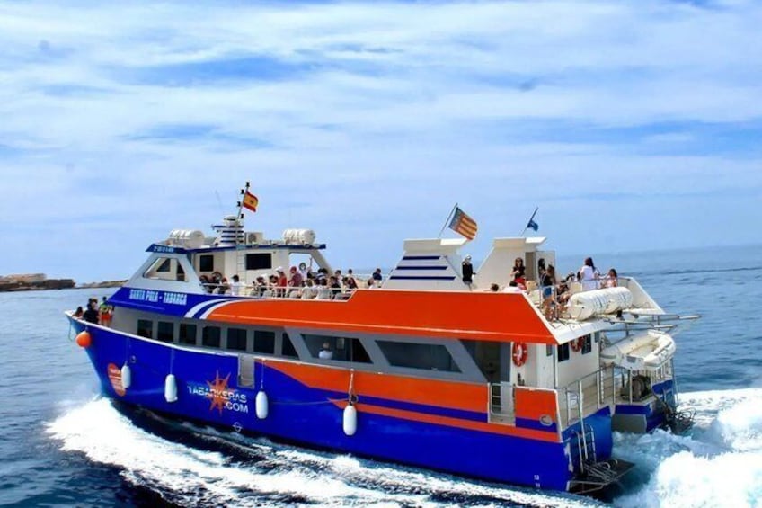A blue and orange boat with people on deck, moving through the water. 2