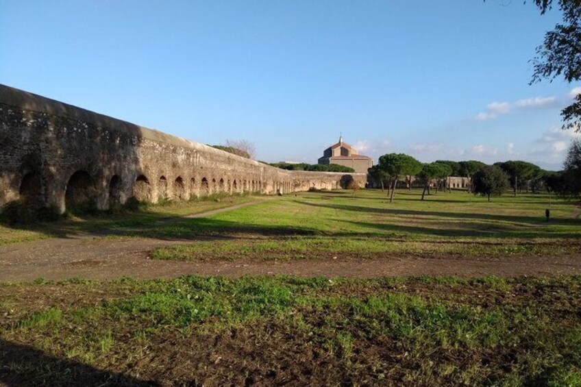 A stone bridge, a domed building, and a grassy field. 3