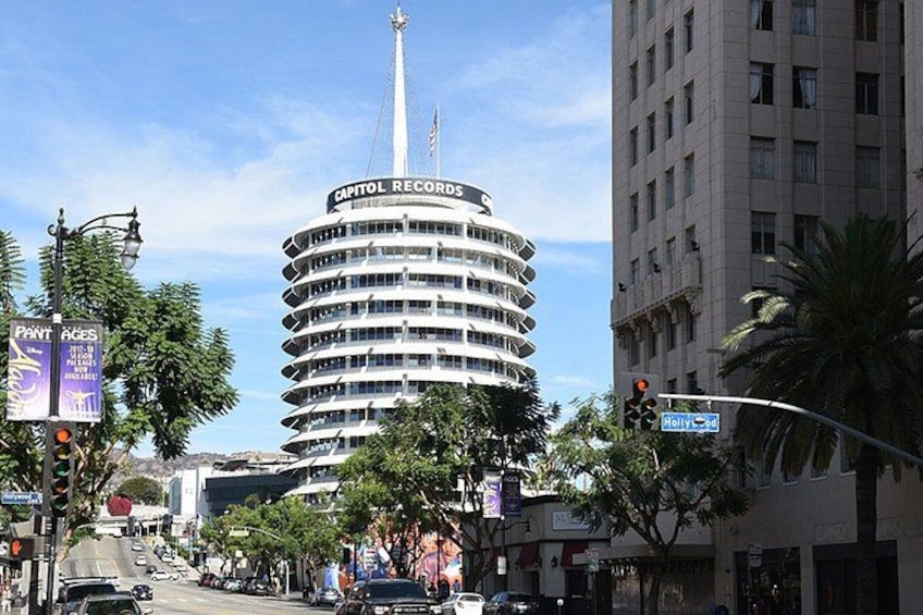 A city street with a tall building labeled 'Capitol Records,' palm trees, and a traffic light. 4
