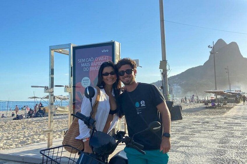 A beach with a signboard, a mountain in the background, and a clear sky. 2