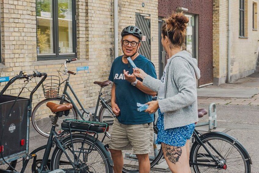 Two people standing by bicycles on a street. 3