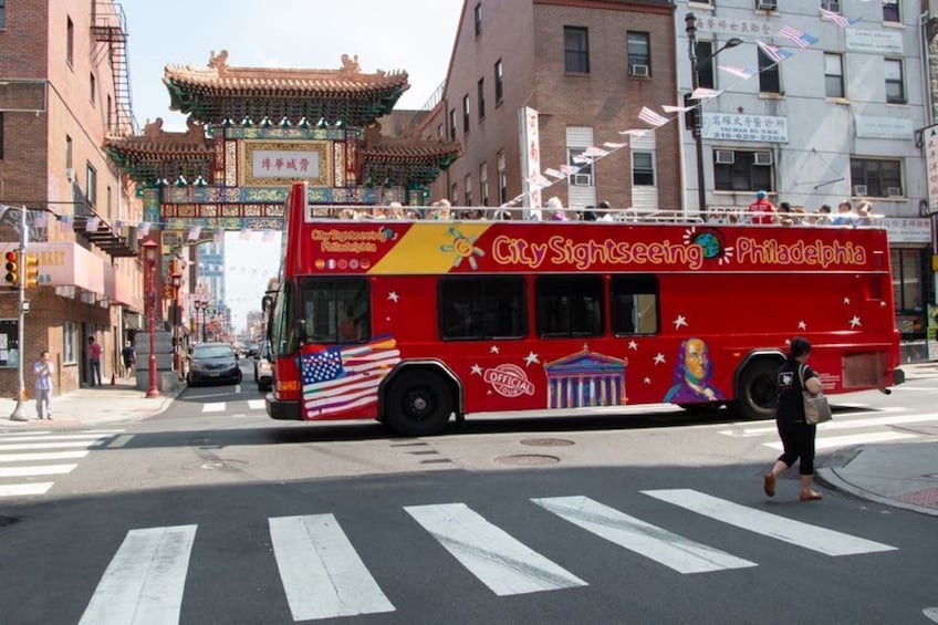 A red City Sightseeing bus with Philadelphia's skyline and the Liberty Bell on its side. 5