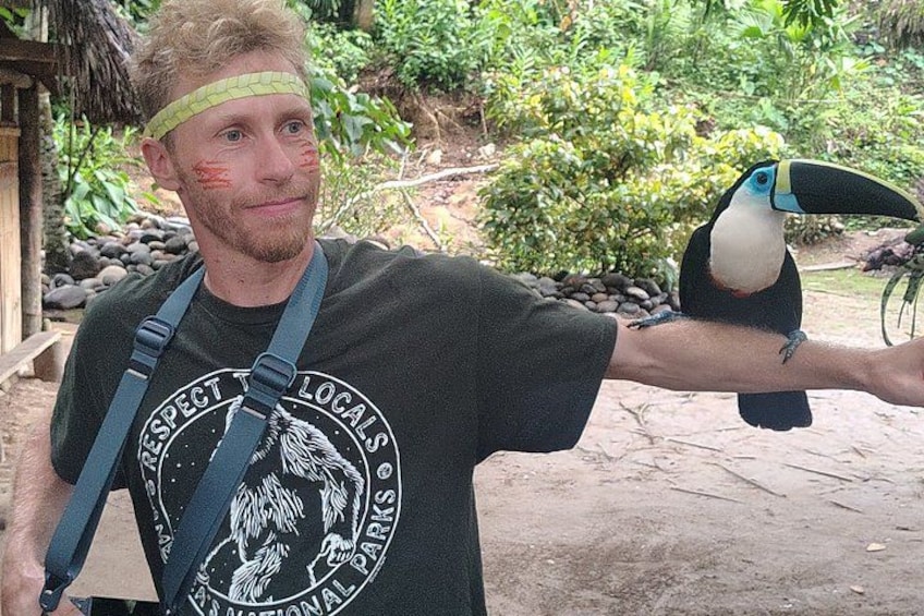 A person holding a toucan. 1