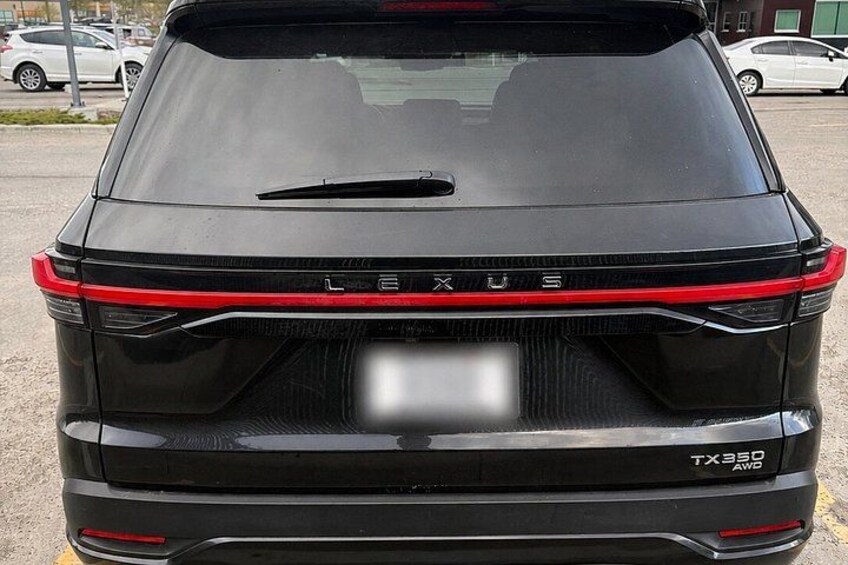 A black Lexus SUV with a visible license plate and the model name 'TX350 AWD' on the rear. 4