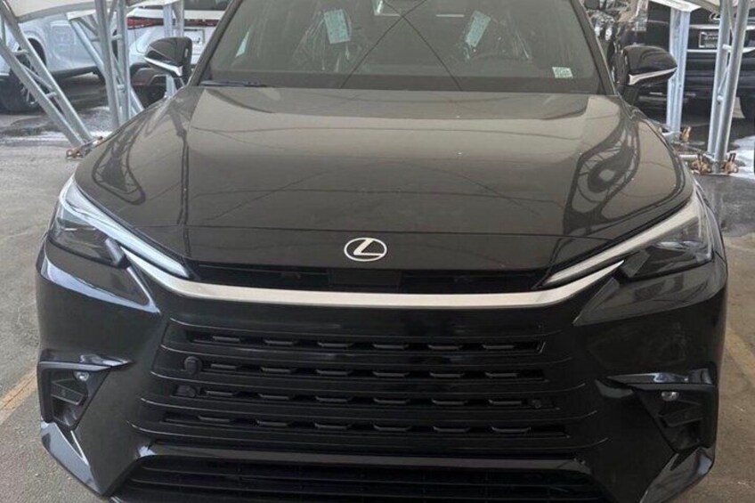 A black Lexus SUV parked in a lot with other vehicles. 3
