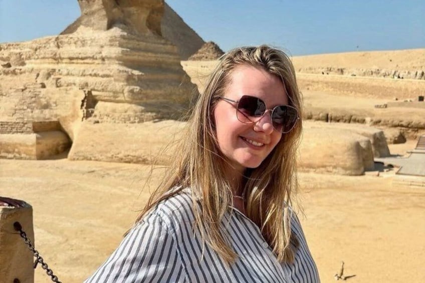 A person in front of a large ancient pyramid structure. 3