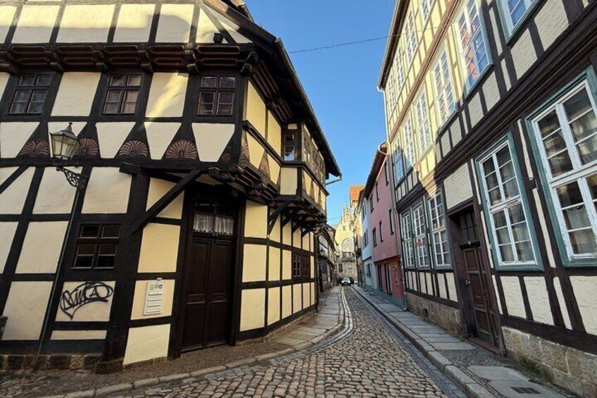 A cobblestone street lined with traditional half-timbered buildings. 4