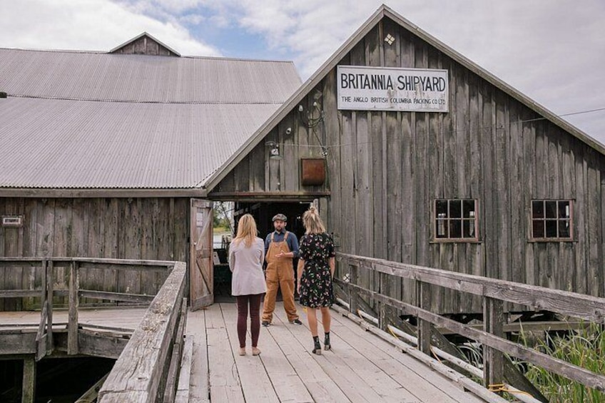 A wooden shipyard with a sign reading 'BRITANNIA SHIPYARD' and a wooden dock. 2