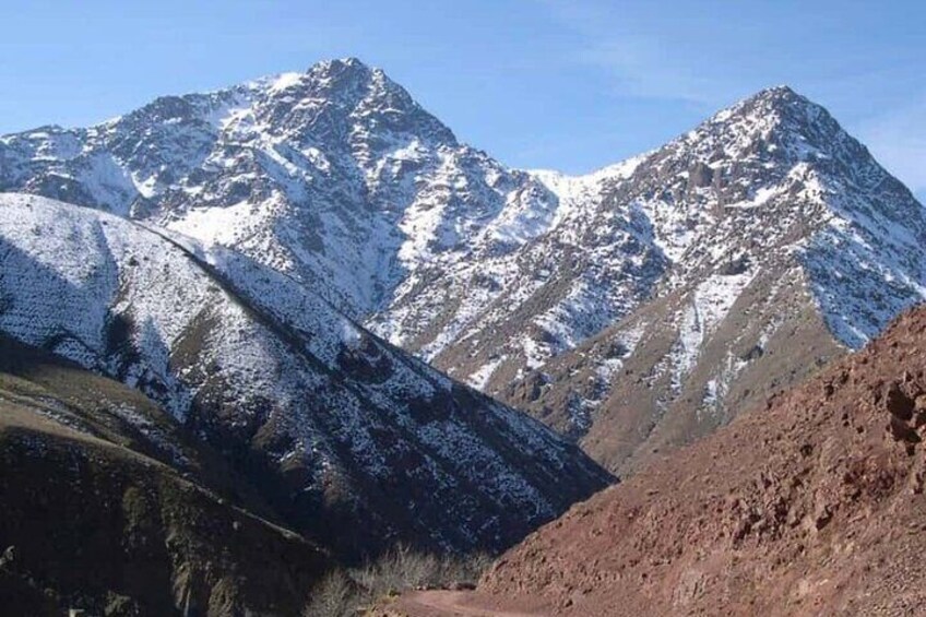 A snow-capped mountain range with rugged terrain. 4