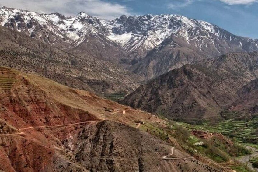 A mountainous landscape with terraced fields and a winding road. 3