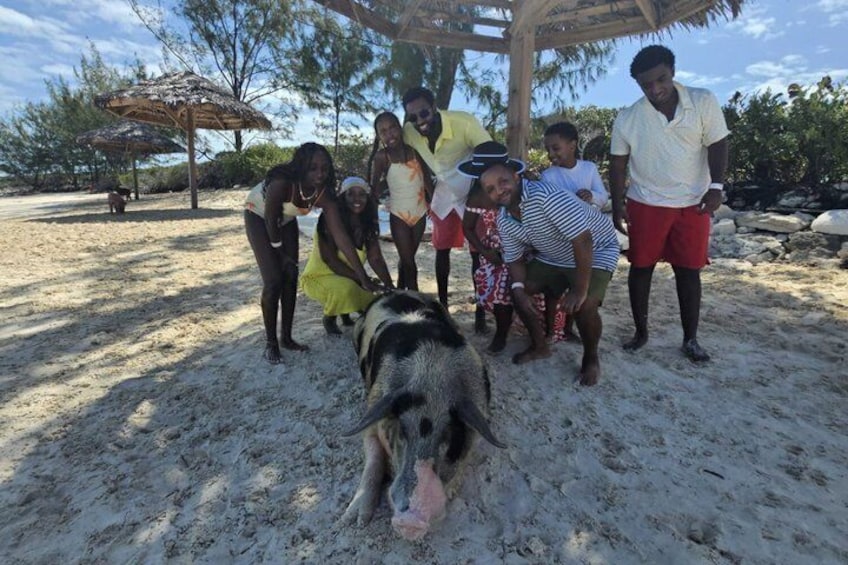 A group of people on a sandy beach with a dog in the foreground. 4
