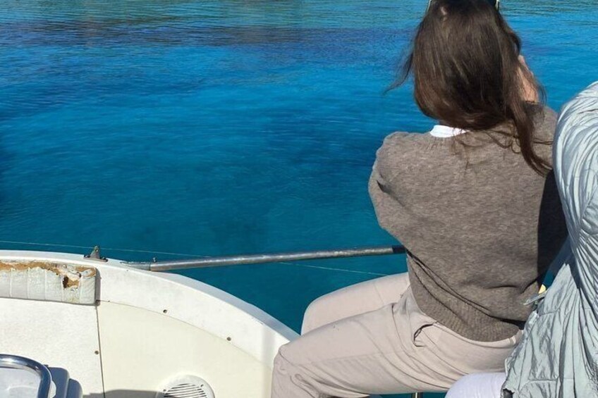 A person on a boat with a clear view of the blue water. 5