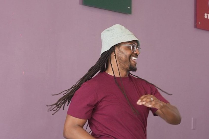 A person with long hair wearing a white hat and a maroon shirt. 5