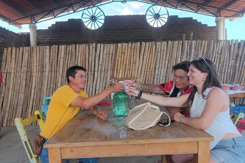 A wooden table with a green bottle and a white bag. 5