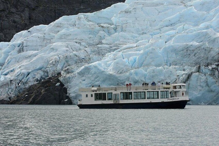 A cruise ship named 'PEARL OF THE ORIENT' near a glacier. 2
