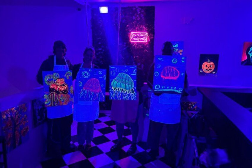 People wearing glowing aprons with designs, in a room with a checkered floor and a neon sign. 3