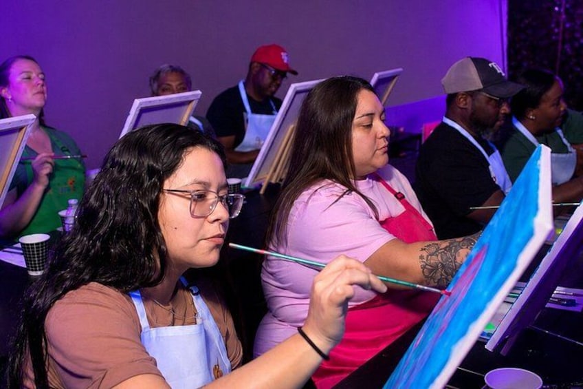 People engaged in painting activities, with easels and canvases. 5
