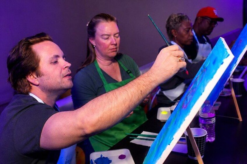 A person painting on a canvas. 1